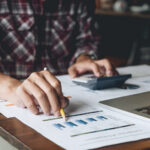 accountant or banker making calculations. Savings, finances and economy business concept