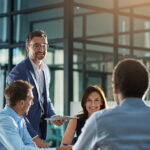 Leader, feedback or business people with tablet for planning, investment research or budget advice. Teamwork, manager and financial advisor in discussion for accounting review, meeting and report
