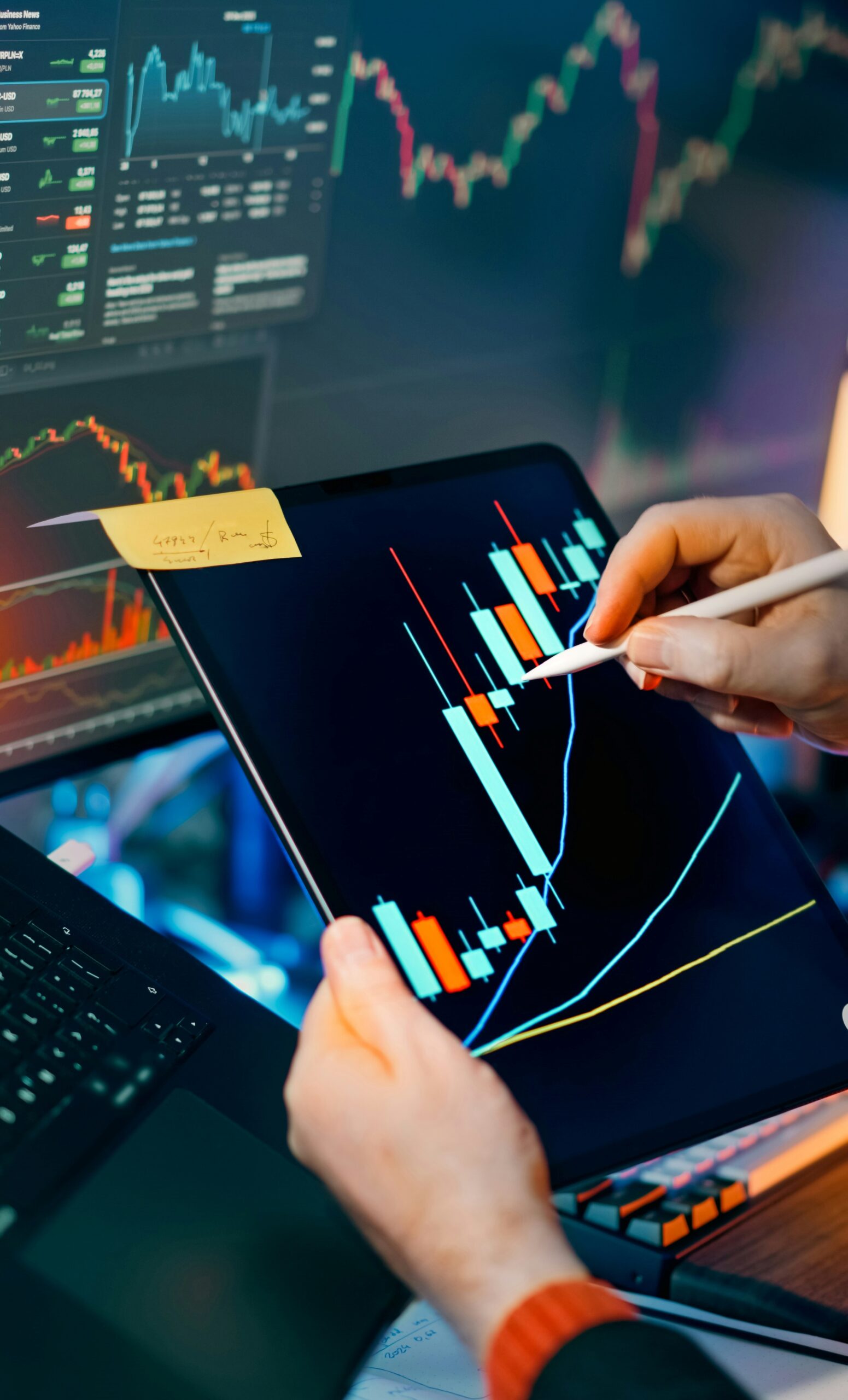 A person analyzing stock market data on a tablet using a stylus, with charts in the background, capturing finance, growth, and investment strategy concepts