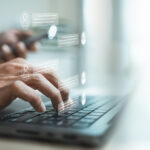 Customer support agent using laptop with virtual live chat interface, representing online assistance, instant messaging, CRM service, AI chatbot communication, help desk response.