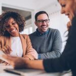 Married couple talking with financial advisor on a meeting